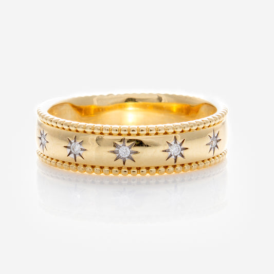 The Solid Gold Bold Star Set Diamond Band features a beaded edge and six star-shaped engravings, each with a sparkling diamond, creating a stunning gold ring shown on a plain white background.
