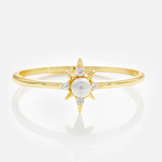 The Celestina Pearl Ring features a central pearl and starburst accents in 14k yellow gold vermeil, detailed with small diamonds at each point, displayed on a white background.