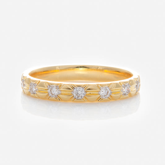 The Solid Gold Vintage Inspired Diamond Band features six lab-grown diamonds in star-shaped engravings around the band, displayed on a reflective white surface.