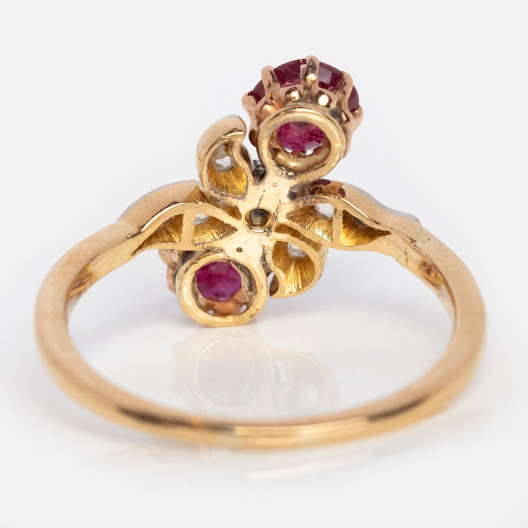 A Vintage 14k Milgrain Ruby and Diamond Crossover Ring, size 5.5, featuring ornate detailing with rubies and diamonds in an elevated prong setting on a plain white background.