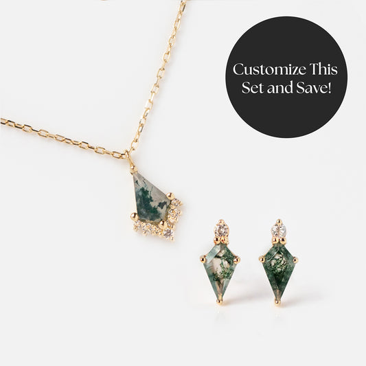 The Modern Gothic Gift Set features a gold chain necklace with a geometric green gemstone pendant and matching aquatic agate earrings, both accented with clear stones. A black circle says Customize This Set and Save! A distinctive gift choice.