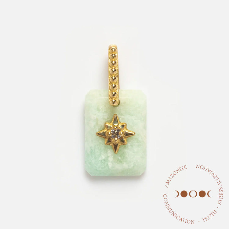The Solid Gold Crystal Amulet Charm for Manifestation is a rectangular light green amazonite pendant with a gold star and gemstone center, dotted gold bail, and circular text with moon phases: communication, truth, intuition.