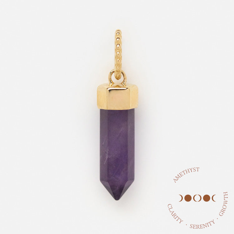 A Solid Gold Crystal Charm for Manifestation with a dotted gold loop sits beside the words AMETHYST, CLARITY, SERENITY, GROWTH and a circular graphic of four crescent moon phases symbolizing powerful manifestation.