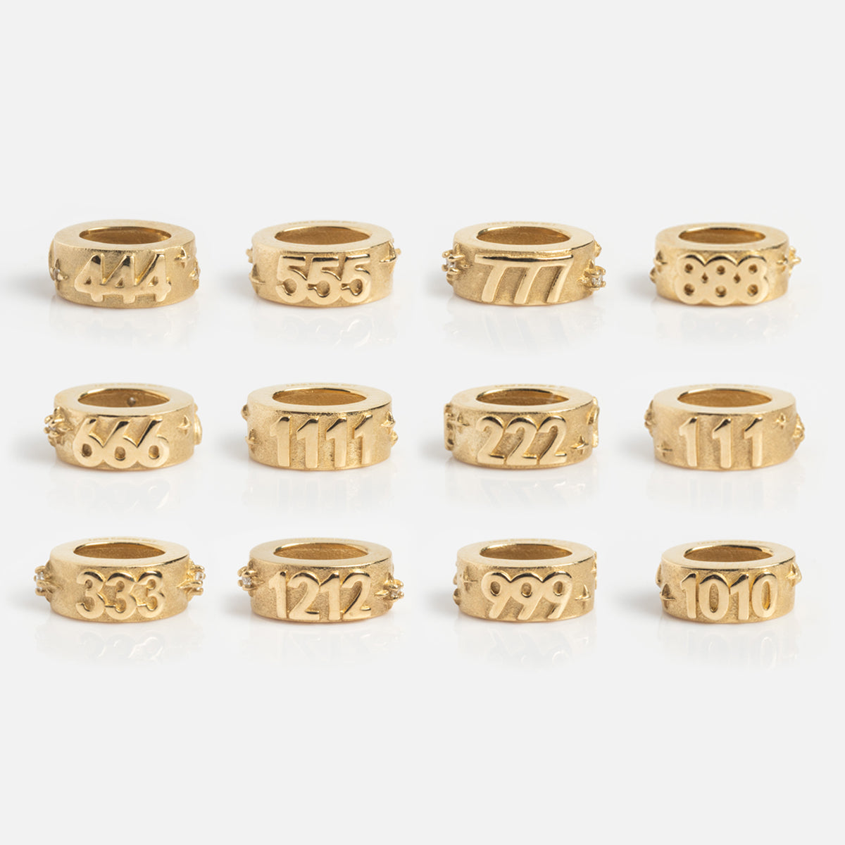 Twelve Solid Gold Angel Number Spacer Charms, each engraved with patterns from 444 to 1010, are exclusive to Local Eclectic—perfect as unique spacers or standout statement pieces.
