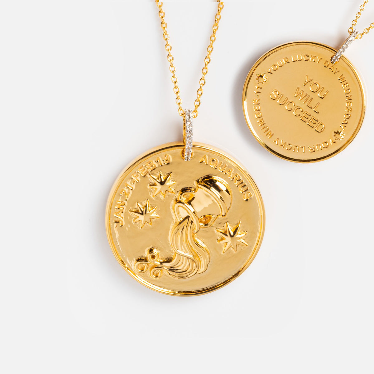 The Vintage Inspired Zodiac Coin Necklace features a gold vermeil round pendant with an Aquarius symbol and stars on the front, and “YOUR LUCKY DAY WEDNESDAY. YOU WILL SUCCEED. AQUARIUS.” engraved on the back for a vintage charm look.