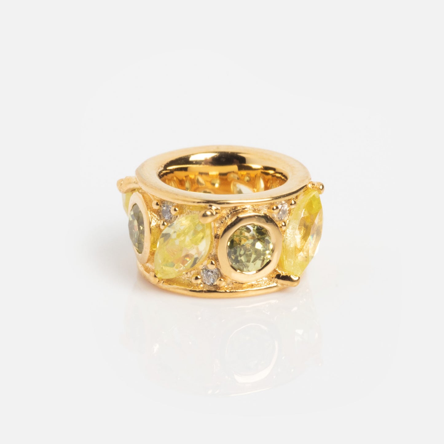 The Shades of You Birthstone Spacer Charm features a wide gold band with large round and oval yellow and green gemstones, accented by small clear stones and birthstone spacers, shown on a white background.