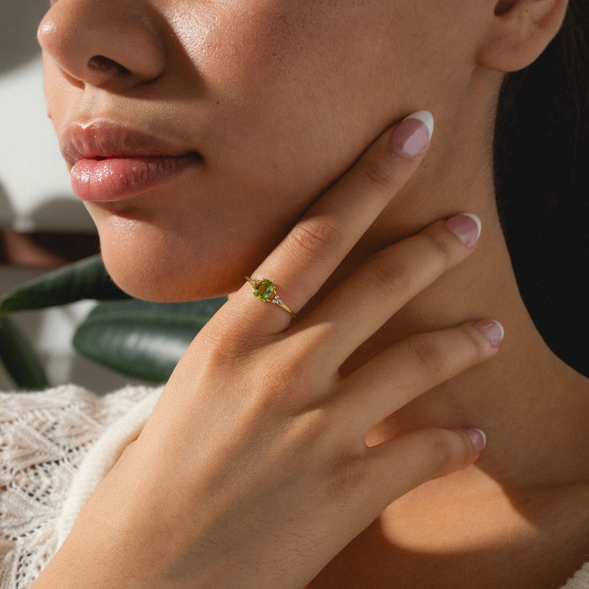 Statement peridot ring worn on woman's finger