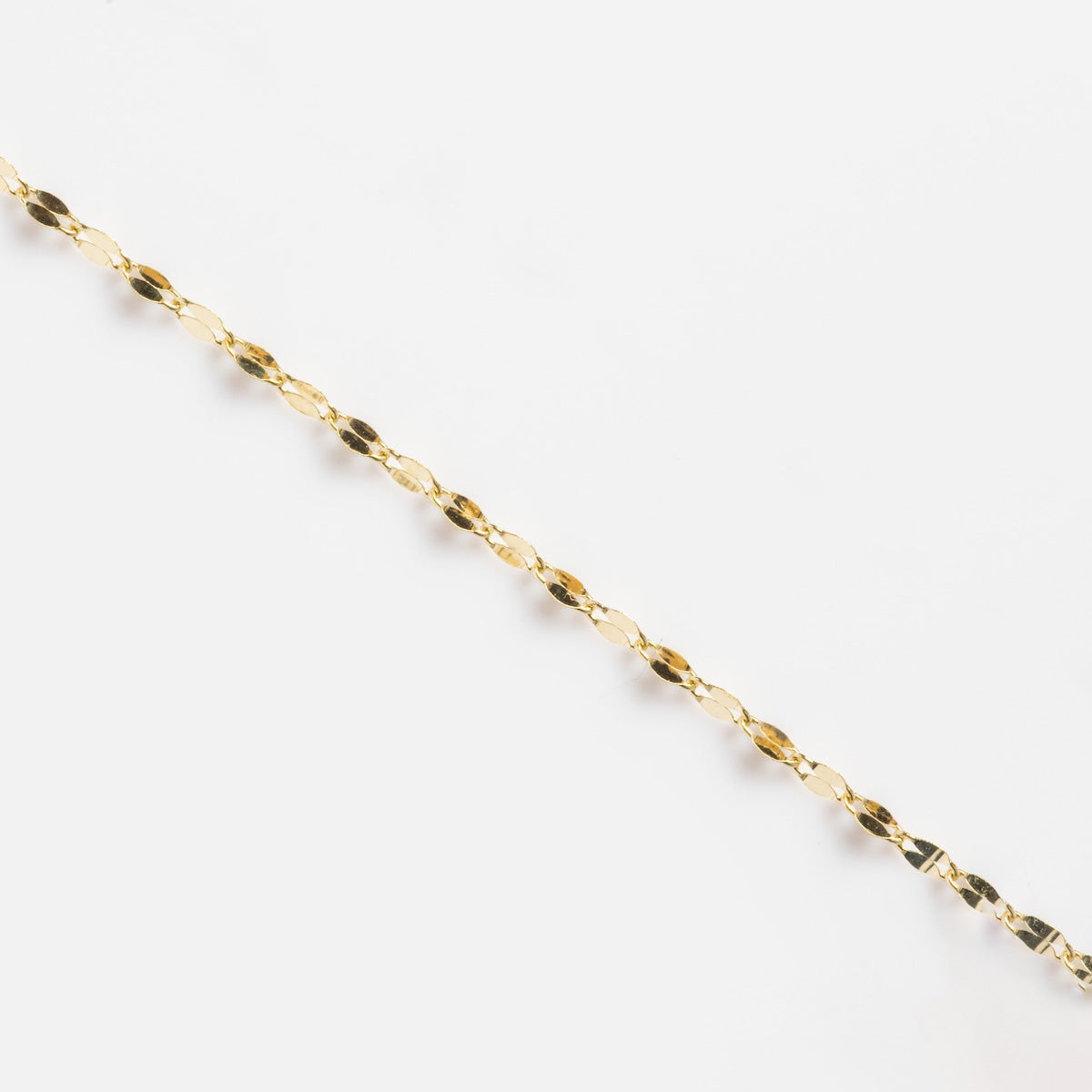 The Solid Gold Italian Sparkle Link Chain is shown diagonally on a plain white background, ideal for enhancing your necklace stack.