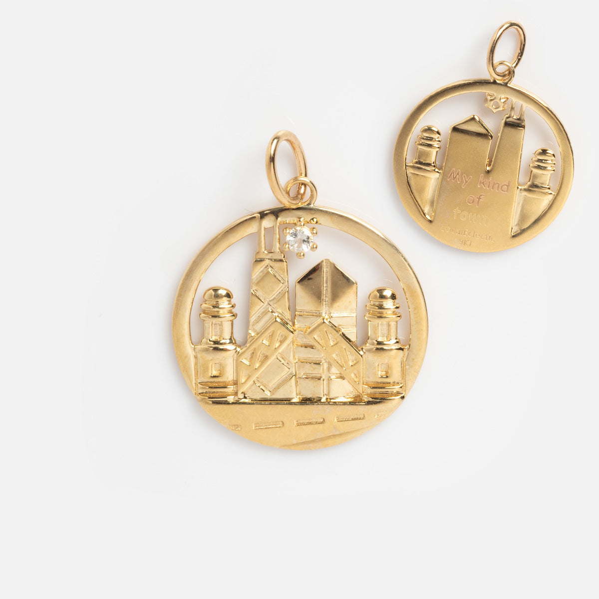 The Solid Gold Chicago Charm features two round pendants with city skylines—one accented with a diamond. Exclusive to Local Eclectic, each open-frame charm is perfect for any solid gold necklace.