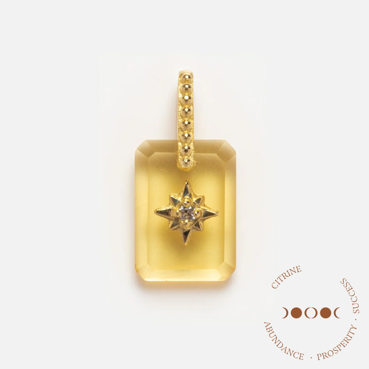 The Solid Gold Crystal Amulet Charm for Manifestation features a rectangular citrine pendant with a gold star accent and small gems, suspended from a gold bail with tiny stones. CITRINE ABUNDANCE PROSPERITY SUCCESS encircles the design.