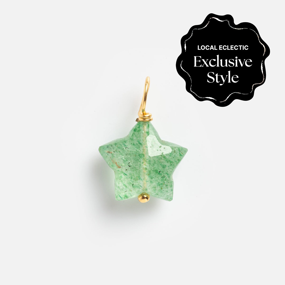 A green star-shaped carved crystal charm pendant with a gold loop, from Devi Arts Collective x Local Eclectic Carved Crystal Charms, displayed on white. A black corner label reads Local Eclectic Exclusive Style—semi precious stone jewelry.