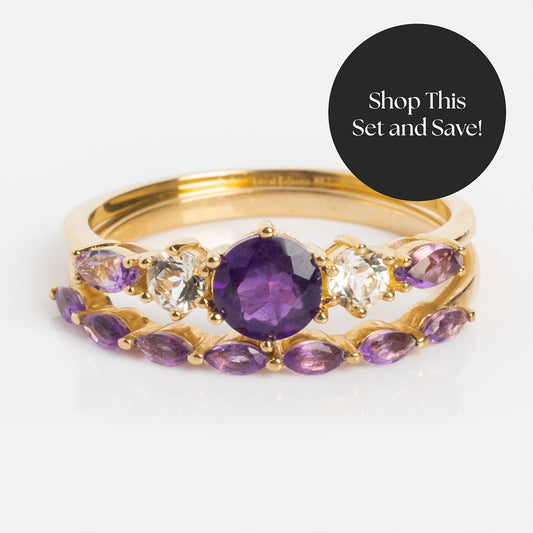 The Solid Gold 2025 February Capsule Amethyst Ring Set features a large central amethyst, clear side stones, and marquise purple gems. Limited edition with a free gift! Black circle overlay: Shop This Set and Save!.