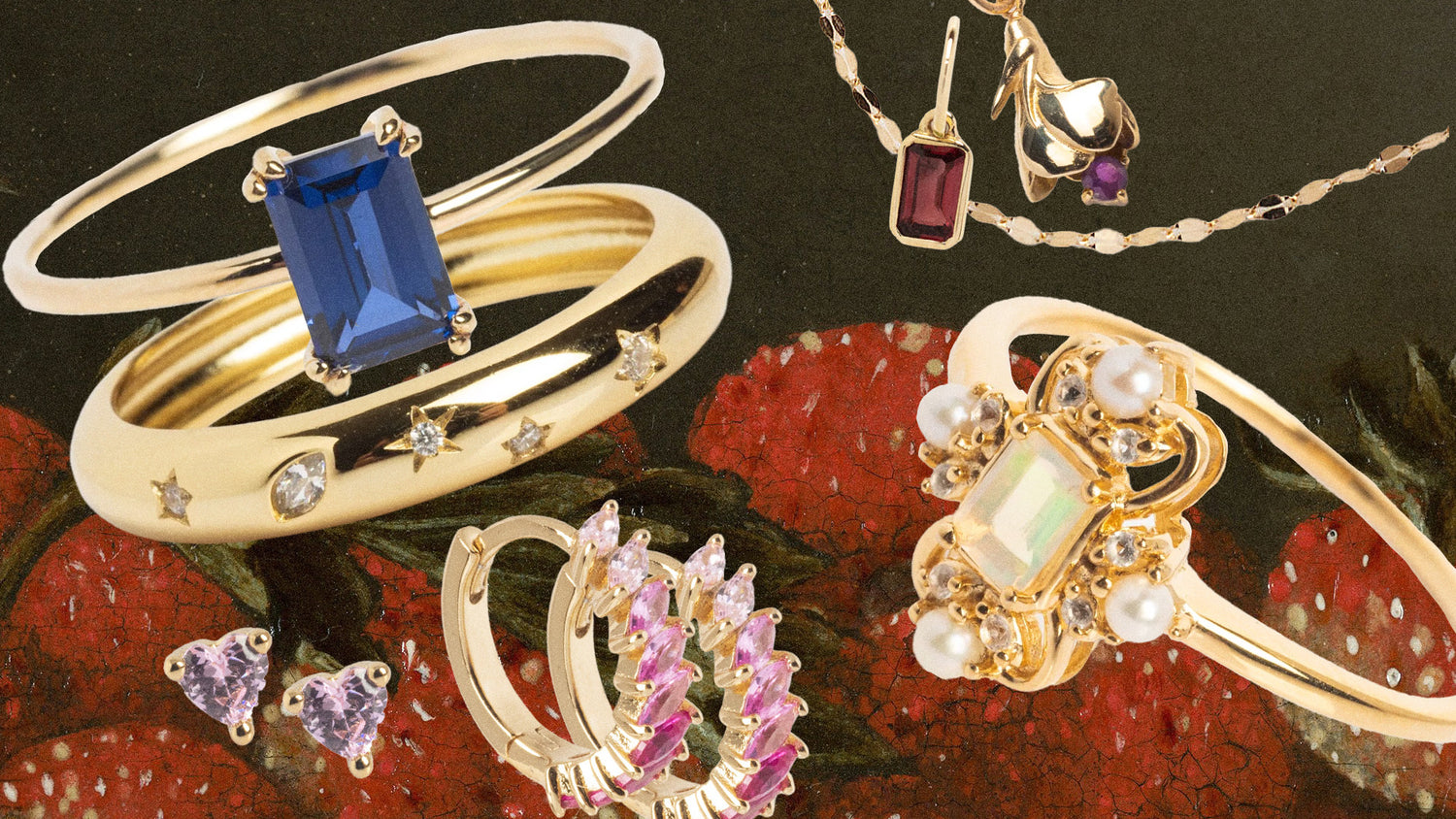 Gold jewelry with gemstones on a textured surface