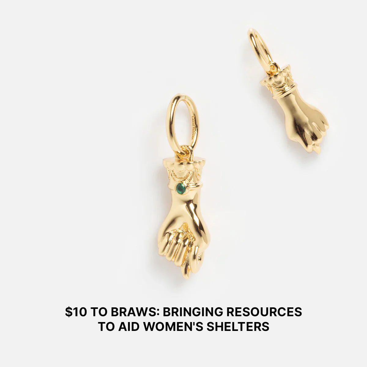 The Limited Edition Women's History Month Charms—two gold hand-shaped charms, one with a green gem—are displayed on white. $10 to BRAWS supports women's shelters. Celebrate Women's History Month with this special charm.