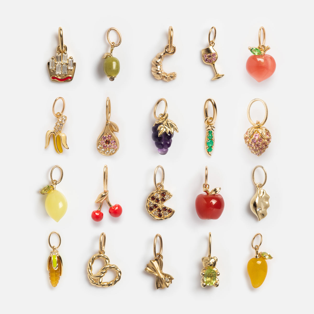 Solid Gold Foodie Charm: a set of 20 small 9k yellow gold charms in fun shapes—fruits, gems, pretzel, wine glass, teddy bear, and more—ideal for a custom necklace. Displayed neatly on white.
