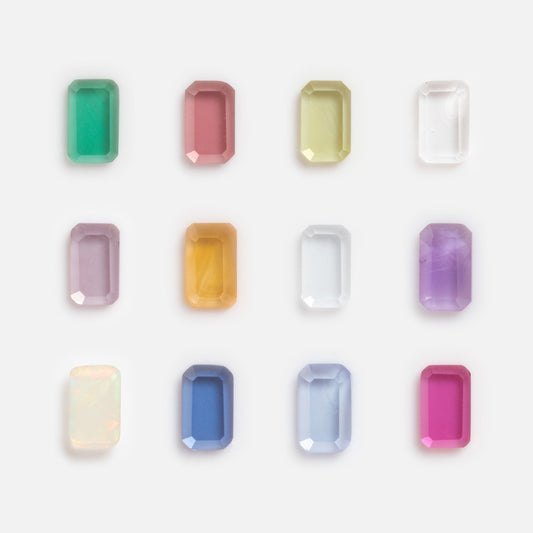 Twelve vibrant Solid Gold Tiny Birthstone Charms for Glass Charm Locket, in colors like green, pink, yellow, and blue, are arranged in a grid—ideal accents for creating personalized jewelry.