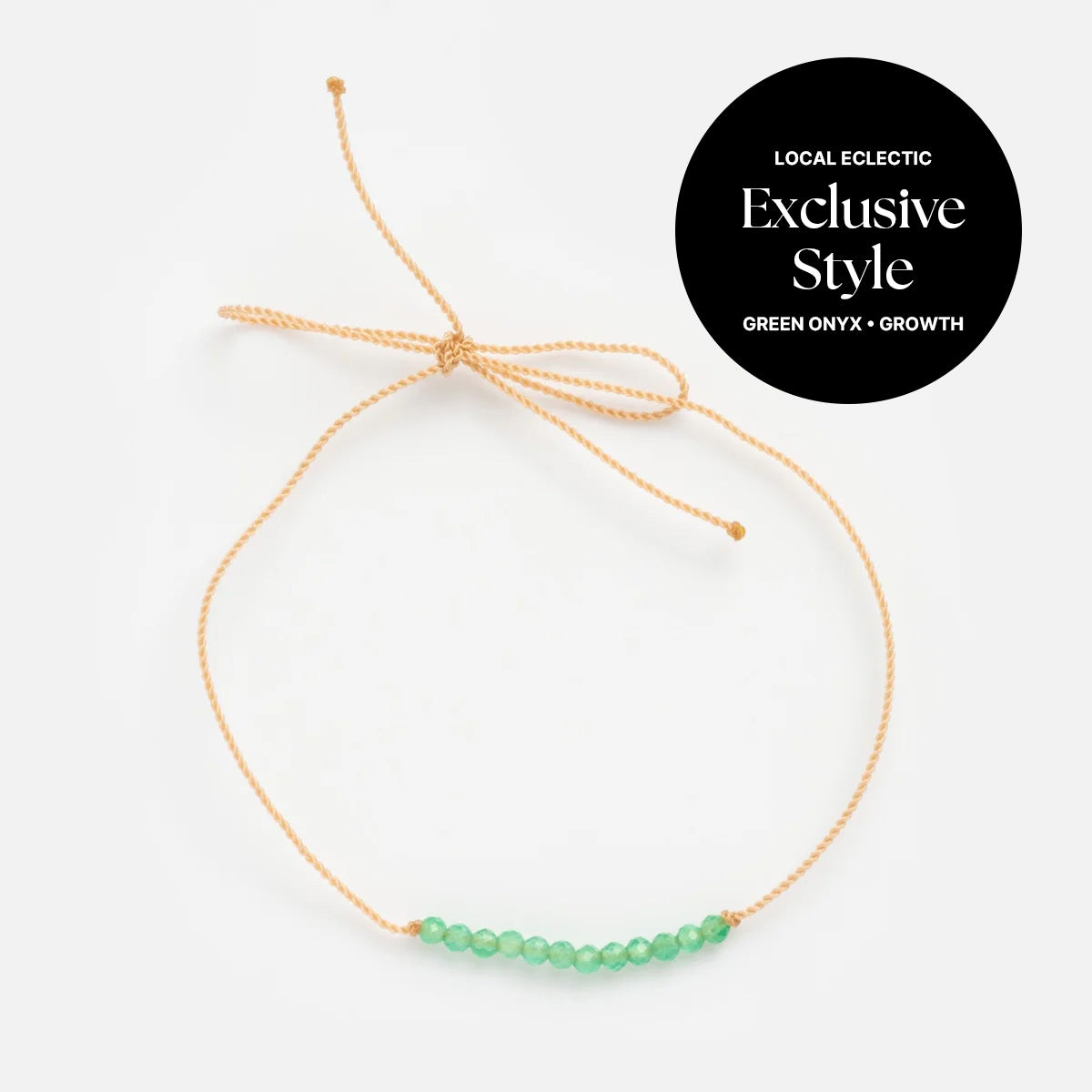 The Anokhi Green x Local Eclectic Gemstone Wish Bracelet features a delicate tan cord with small green onyx beads and an adjustable knot. A black circle reads: Local Eclectic Exclusive Style, Green Onyx + Growth.