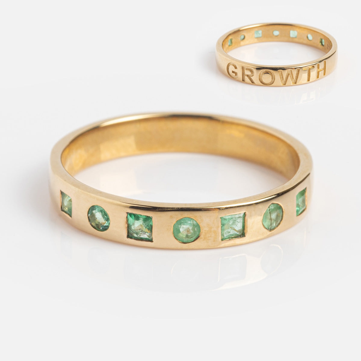 The Solid Gold Within You Birthstone Band Sample Size 7, crafted in 9k yellow gold with a 3.1 mm band, showcases alternating square and round natural green stones and features GROWTH engraved inside the band.