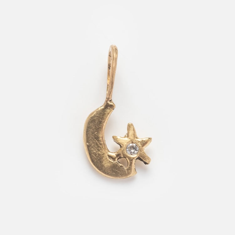 Acanthus 14k Solid Gold Tiny Charms: Crescent moon and star pendant with a central clear gemstone, crafted in solid yellow gold—an elegant piece displayed on a plain white background.