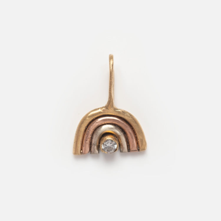 The 14k Solid Gold Tiny Charms by Acanthus feature a gold and silver pendant with a diamond, beautifully crafted in 14k solid yellow gold for an elegant touch.