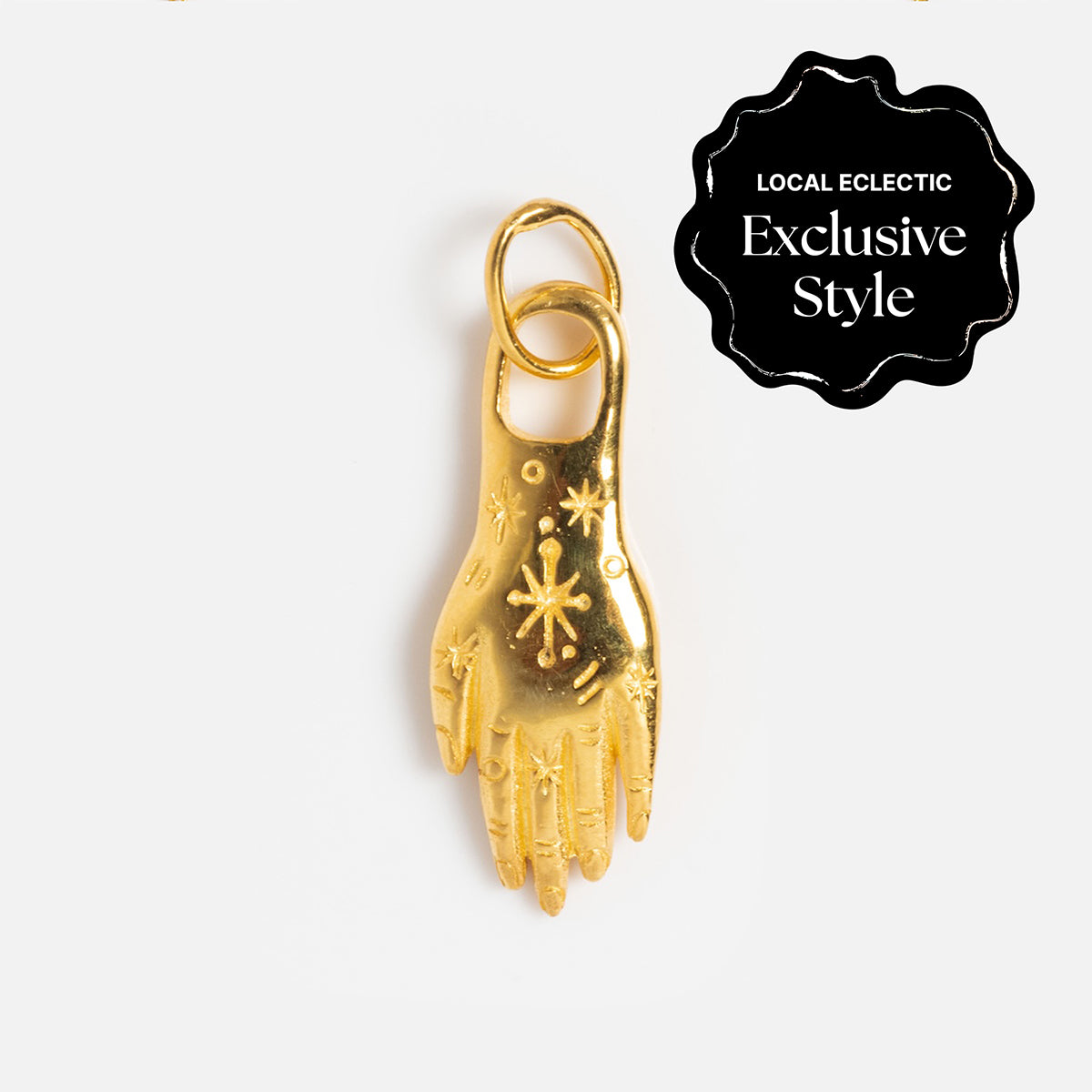 A gold vermeil hand-shaped charm with star and dot engravings from Charms by Hunt of Hounds is shown on a white background. A black badge at the top right says LOCAL ECLECTIC Exclusive Style.