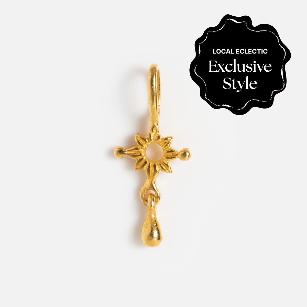 Charms by Hunt of Hounds: Gold vermeil sunburst charm with a dangling teardrop, shown on white. A black label reads Local Eclectic Exclusive Style. Ideal for layering with your other charms.