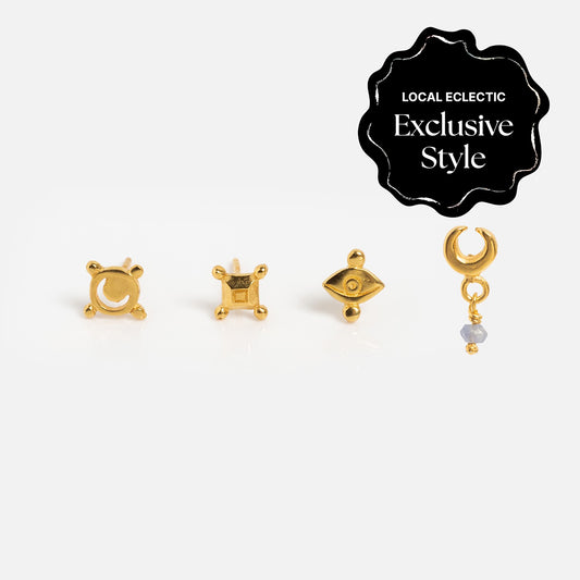 The Hunt of Hounds x Local Eclectic Dreamlight Stud Set features four gold celestial stud earrings—crescent moon, square, eye, and crescent moon with a dangling gem—shown on a white background with a Local Eclectic Exclusive Style black seal.