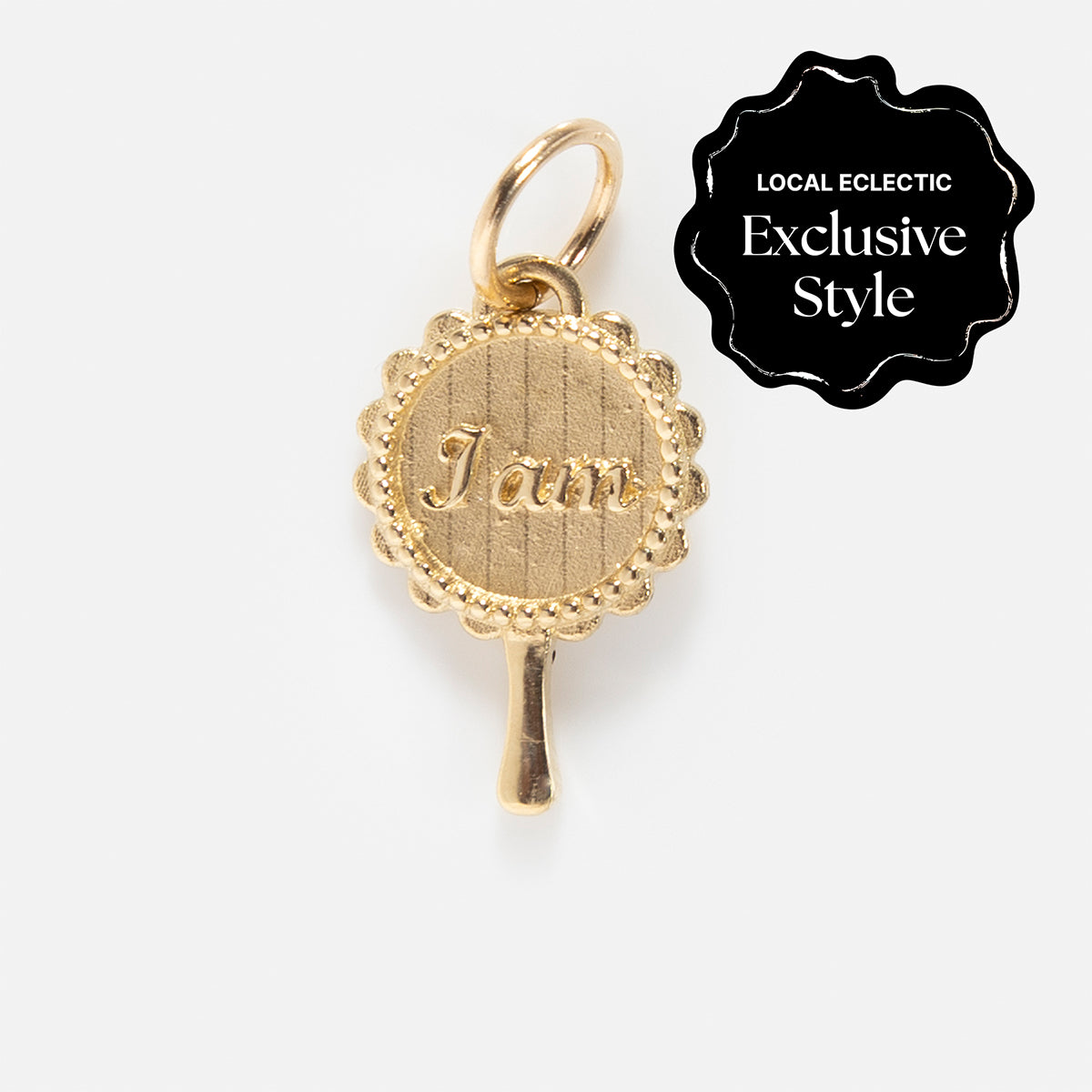 The 14k Littlest Charms by Charlie and Marcelle features a gold, scalloped-edge jam jar lid charm engraved with “Jam” on a small loop. This Local Eclectic exclusive is perfect for adding a personalized touch to your necklace.