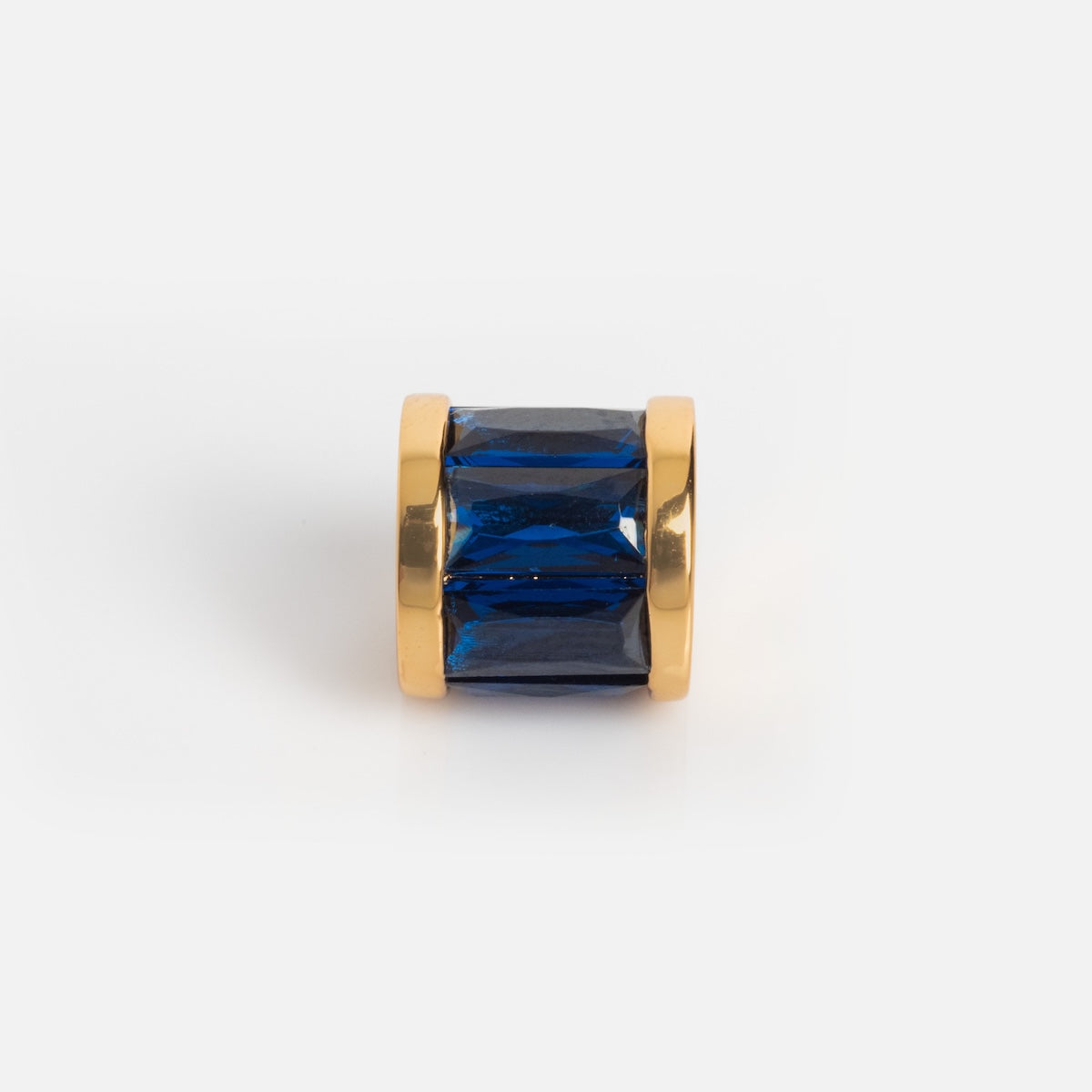Charms by Thatch features a gold-plated cylindrical charm with a large rectangular blue gemstone at its center, displayed on a white background—ideal for personalizing your necklace.