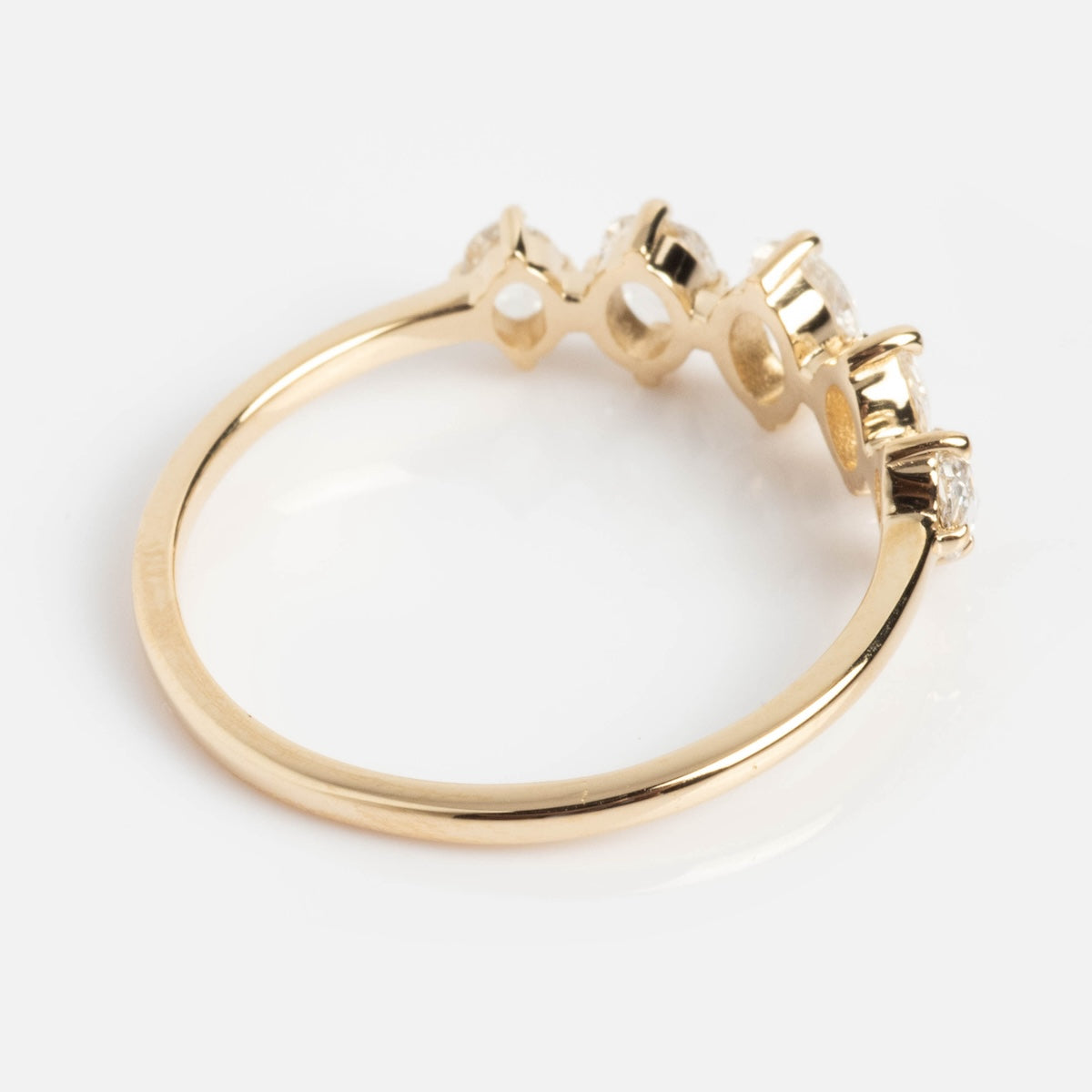 The Nadine Ring with Rose Cut Diamonds features four round rose cut diamonds set in prongs on solid gold, shown from the side against a white background.