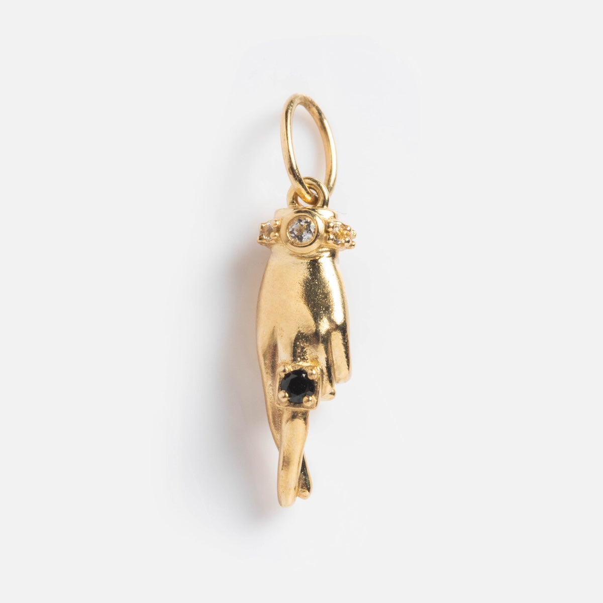 Exclusive to Local Eclectic, the Solid Gold Body Language Charm is hand-shaped with a clear gemstone ring on one finger and a black stone in the palm, displayed against a plain white background.