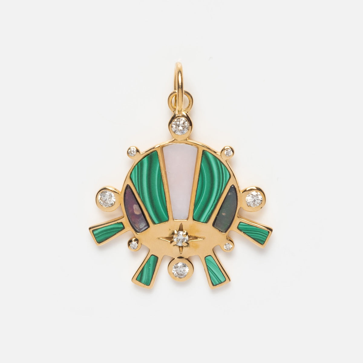 The Bioluminescent Charm is a solid gold necklace with green, pink, and black inlays and round diamonds at its center and edges, styled like an eye or sunburst, shown against a plain white background.