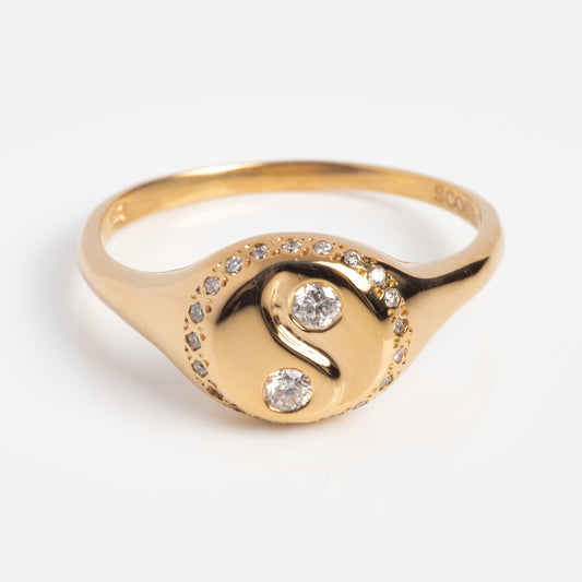 The Yin Yang Signet Ring in 14k solid yellow gold showcases white diamonds in the symbol and a diamond-studded border, beautifully photographed on a plain white background.