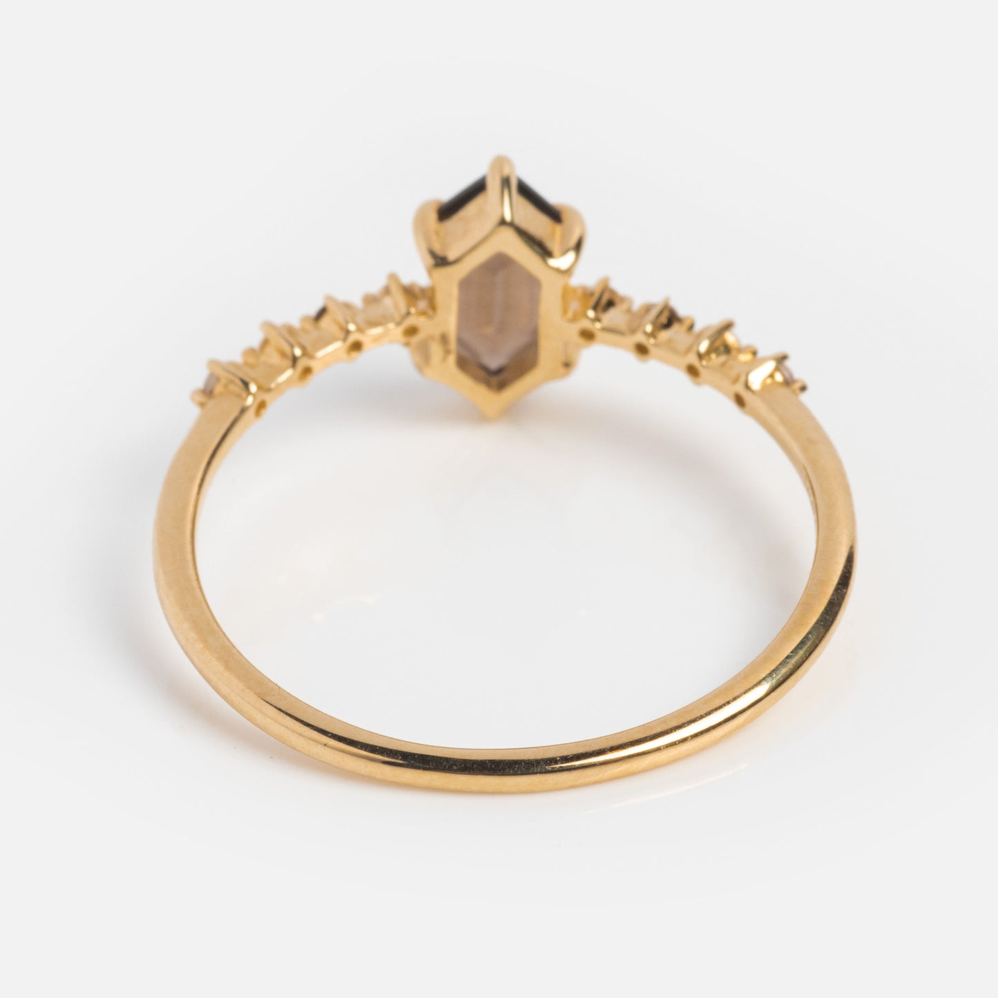 A Local Eclectic exclusive, the Solid Gold Smoky Quartz Hexagon Ring for Courage showcases a geometric smoky quartz setting with delicate band accents, elegantly displayed on a white surface.