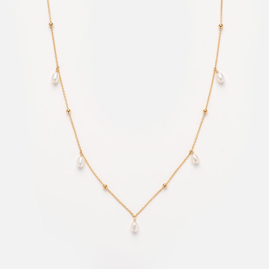 The Solid Gold Pearl Droplet Necklace features a fine gold chain with evenly spaced small pearls and gold beads, shown against a plain white background.