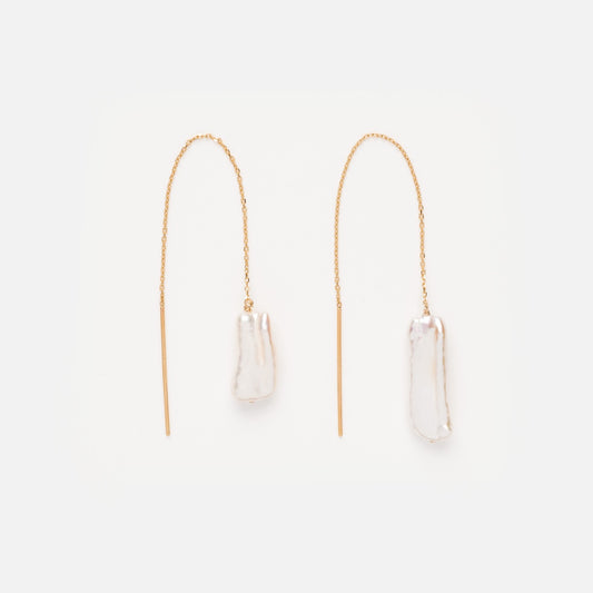 The Solid Gold Baroque Pearl Threader Earrings feature long, delicate chains with irregular white pearls at each end, shown against a plain white background.