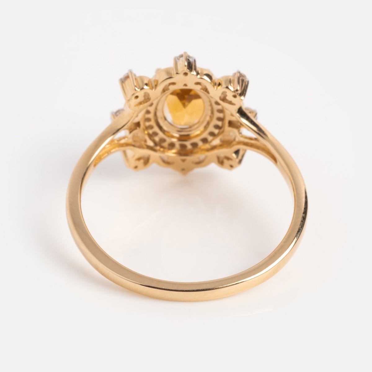 The 14k Vintage Inspired Citrine Statement Ring showcases a round yellow citrine center stone with clear accents in a decorative setting, displayed from the side on a white background.