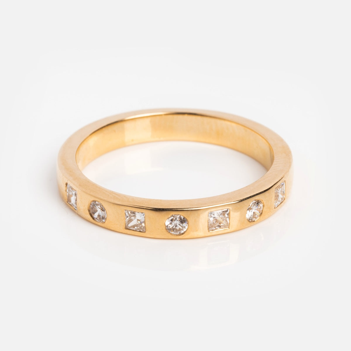 The Solid Gold 2024 April Capsule Diamond Statement Band Sample Size 7 features a flat-profile yellow gold band with alternating round and square lab diamonds set evenly in 9k gold, shown on a white background.