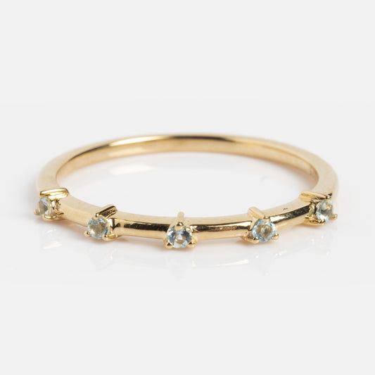 The Solid Gold 2025 March Capsule Aquamarine Full Set features five evenly spaced round aquamarine gemstones on a thin gold band, making it an elegant birthstone jewelry piece, beautifully displayed on a white background. Includes free gift.