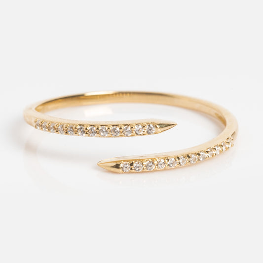 The Solid Gold 2025 April Capsule White Topaz Wrapped Stacking Ring features a nail-inspired wrap design, tapering to points with sparkling white topaz stones encrusted along the top.