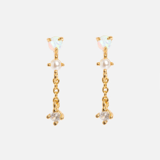 The Opal Studs with CZ Chain Dangle are 18k yellow gold drop earrings featuring opal studs, a center pearl, and a clear crystal accent, all linked by delicate gold chains. Displayed on a white background.