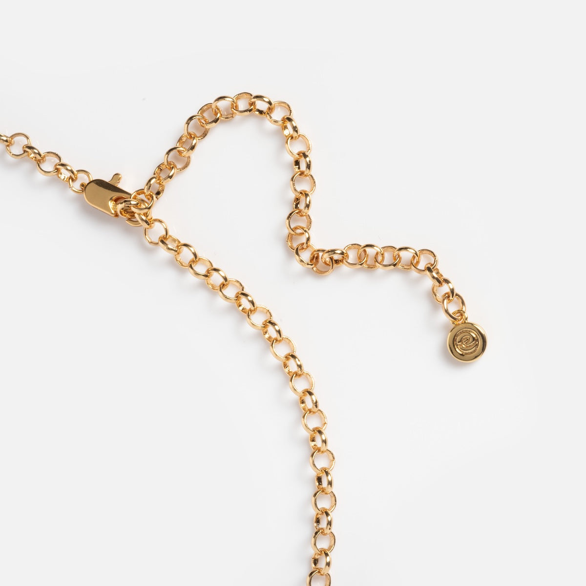 A close-up of the Queen Crystal Birthstone Charm Necklace, featuring adjustable round gold links, a lobster clasp, an extender chain with a small circular charm, all displayed on a plain white background.