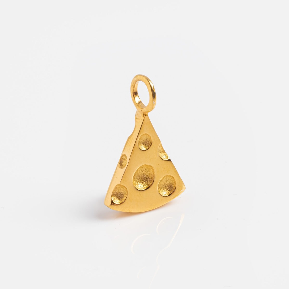 The Charms by Hunt of Hounds gold vermeil pendant features a whimsical Swiss cheese wedge design with circular holes, shown on a white background—an ideal addition to your charm collection.