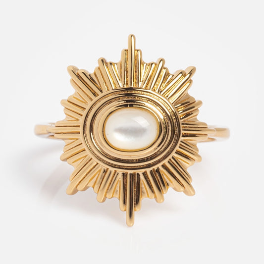 The Supernova Ring features a sunburst gold design with a central oval mother of pearl, displayed on a plain white background.