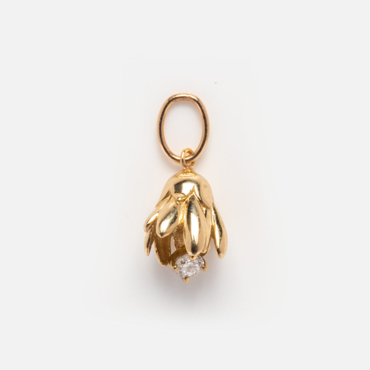 The Solid Gold Birth Flower Bud Charm features layered petals and a clear gemstone at its center, displayed against a plain white background.
