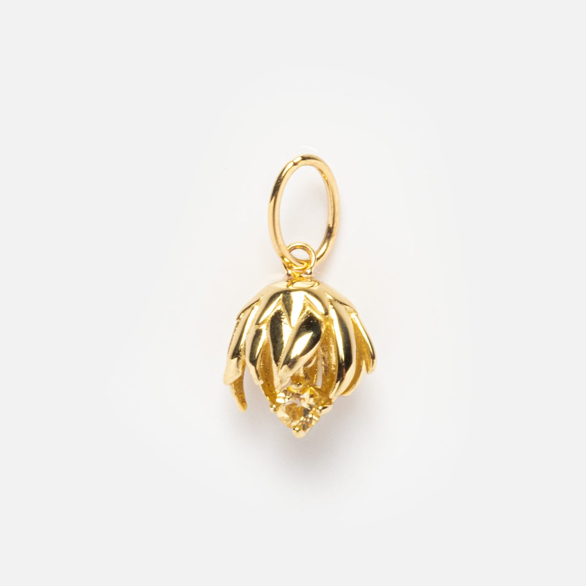 The Solid Gold Birth Flower Bud Charm is a pendant shaped like an artichoke bud with detailed leaves and a central diamond, displayed against a plain white background.