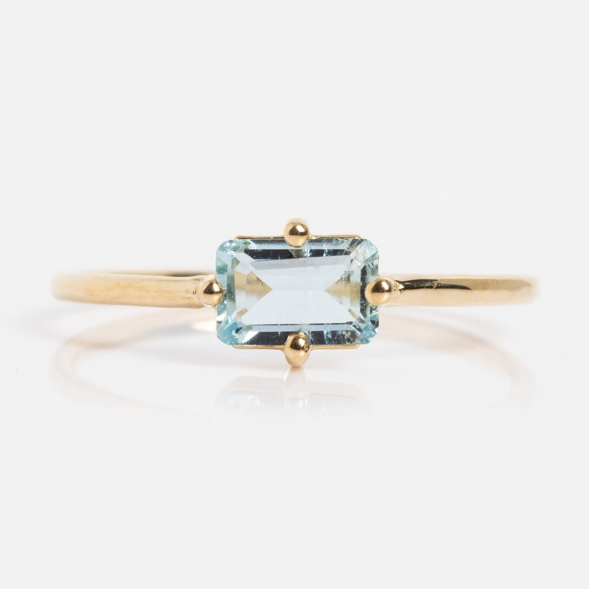 The 14k Mod Love Birthstone Ring features a rectangular light blue gemstone in a four-prong setting, shown against a white background.