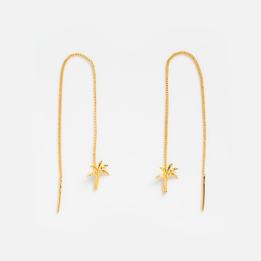 Isla Earrings: Gold threaders featuring delicate 24k gold plated palm tree charms at the ends, each with a thin, long chain and palm tree-shaped pendant, displayed on a white background.