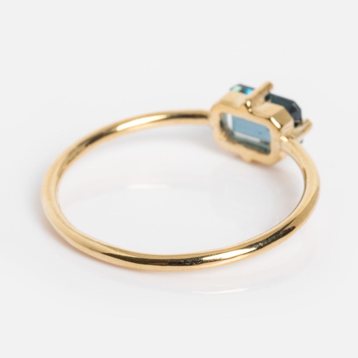 The 14k Mod Love Birthstone Ring showcases a rectangular blue gemstone in a prong setting, set against a white background for an elegant look.