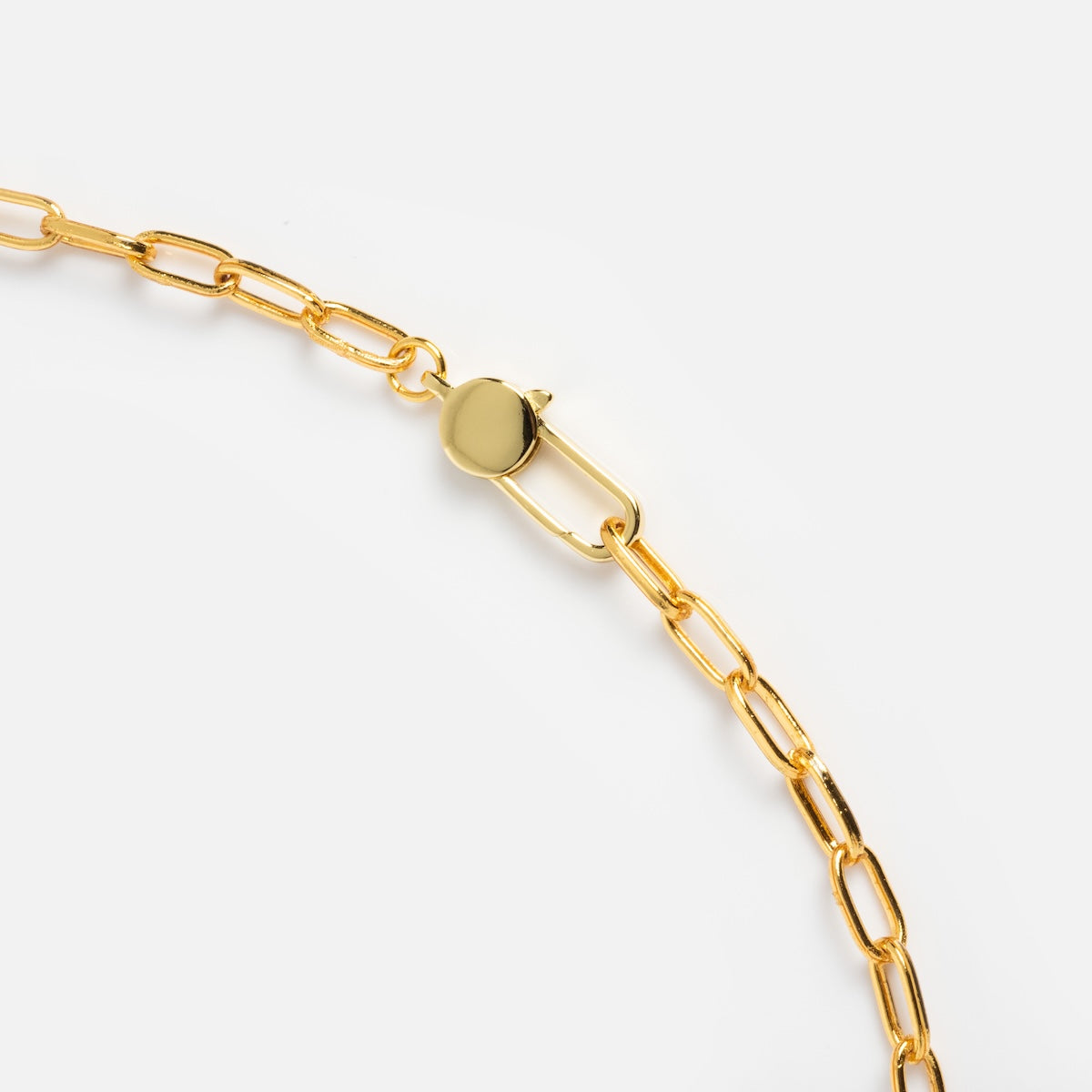 Close-up of the Juicy Cherry Necklace, a gold-plated chain with elongated oval links and a round clasp, set against a plain white background—an elegant statement piece for any occasion.